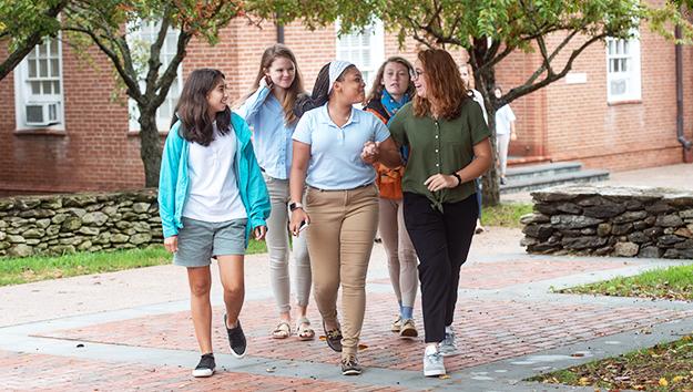Foxcroft School Virginia 2027: Học phí trường nội trú nữ 5 Nhóm nữ sinh trường Foxcroft School Virginia cùng nhau đi bộ trên lối đi lát gạch trong khuôn viên trường